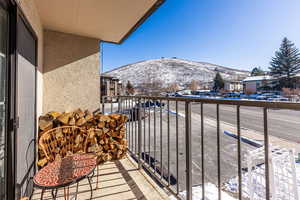 Snow covered back of property featuring a mountain view