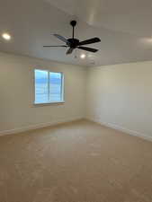 Carpeted empty room featuring ceiling fan