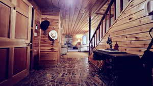 Hallway with wooden ceiling and wooden walls