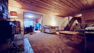 Carpeted living room with wooden ceiling