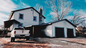 Rear view of property featuring a garage