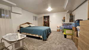 Carpeted bedroom with a textured ceiling
