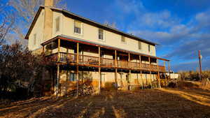 Back of property with a wooden deck
