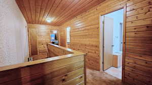 Corridor with wooden ceiling and wood walls