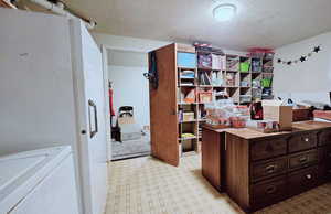 Office area featuring a textured ceiling and washer / clothes dryer