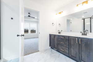 Bathroom featuring vanity and ceiling fan