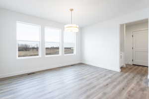 Unfurnished dining area featuring light hardwood / wood-style flooring