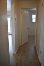 Hall with hardwood / wood-style floors and a textured ceiling