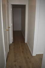 Hallway with dark wood-type flooring