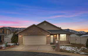 View of front of property with a mountain view and a garage