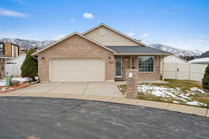 View of front of home featuring a mountain view and a garage