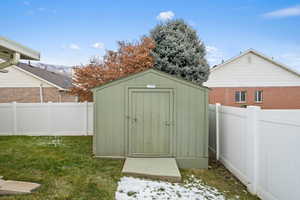 View of outdoor structure with a yard