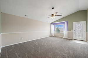 Interior space featuring a textured ceiling, ceiling fan, and lofted ceiling