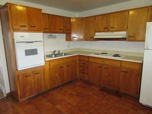 Kitchen with sink and white appliances