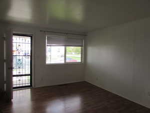 Empty room with dark wood-type flooring