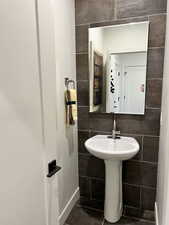 Bathroom featuring tile walls and tile patterned flooring