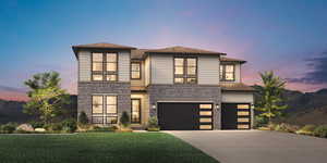 View of front facade featuring a yard and a garage