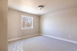 Unfurnished room featuring carpet flooring