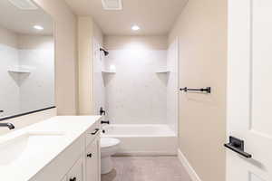 Full bathroom featuring shower / tub combination, toilet, vanity, and tile patterned flooring