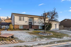 View of front of home featuring a garage and a mountain view