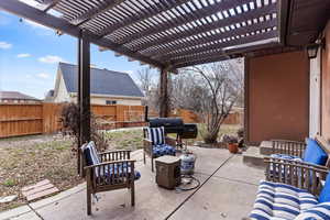 View of patio / terrace with area for grilling and a pergola