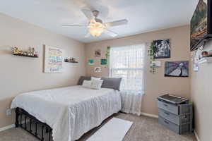 Bedroom featuring light carpet and ceiling fan