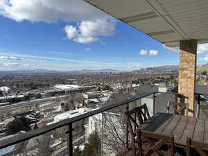 Snow covered back of property featuring a mountain view