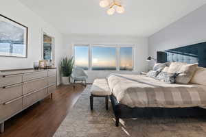 Bedroom with dark hardwood / wood-style flooring