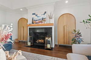 Living room featuring dark hardwood / wood-style floors and ornamental molding