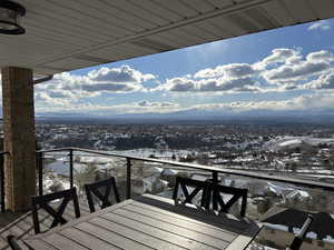 Snow covered back of property with a mountain view