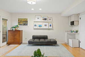 Living area with light hardwood / wood-style flooring