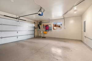 Garage with a garage door opener and electric panel