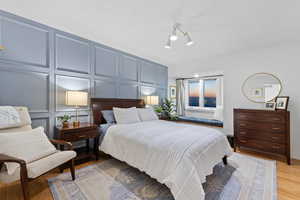 Bedroom featuring light hardwood / wood-style floors and a chandelier