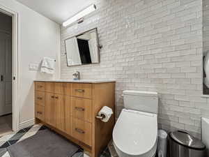 Bathroom with tile patterned floors, toilet, and vanity