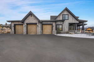 View of front of home featuring a garage and a porch