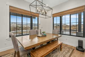 Dining space featuring a mountain view, a chandelier, and light hardwood / wood-style floors