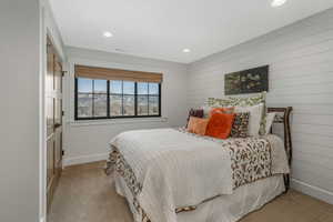 Bedroom 4 featuring light colored carpet and shiplap accent walls