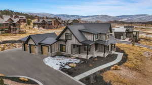 View of front of property with a mountain view and a garage