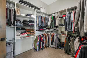 Walk in closet with carpet floors