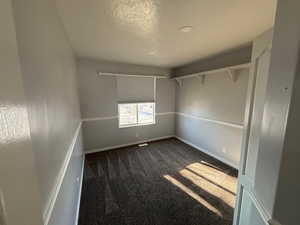 Carpeted spare room with a textured ceiling