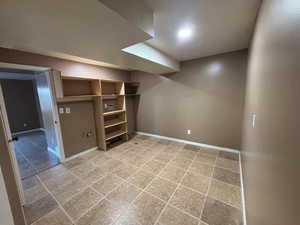 Laundry room in basement with washer and electric dryer hookups