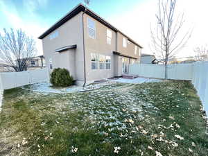 Rear view of property with a lawn