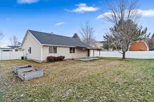 Backyard with covered patio, auto sprinkler system and mature trees.