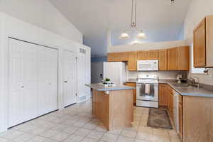 Kitchen with island, Fridge, dishwasher, range and microwave included.