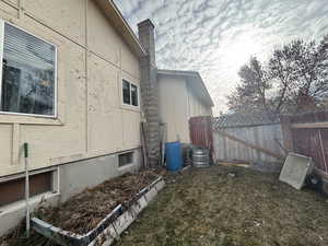 View of side of property with a lawn