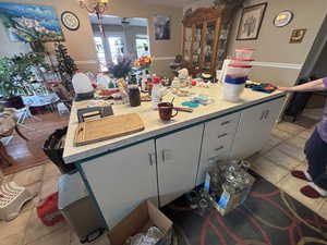 Kitchen featuring white cabinets and light tile patterned flooring