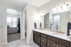 Bathroom with toilet, a wealth of natural light, a shower with shower door, and vanity