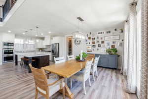 Dining space featuring light wood-type flooring and sink