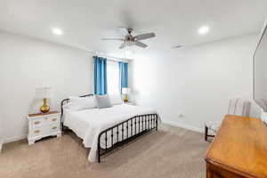 Bedroom featuring ceiling fan and light carpet