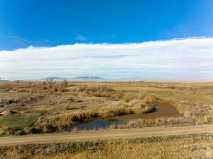 Aerial view with a water and mountain view and a rural view